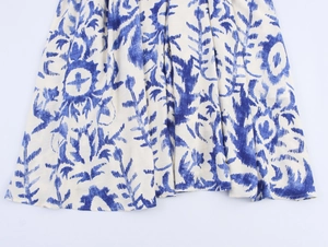 Detail of blue and white floral pattern on bohemian style long sleeve maxi dress fabric