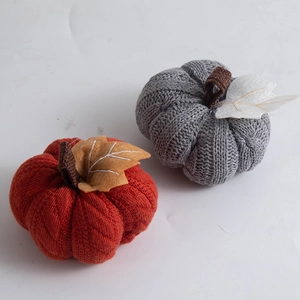 Decorative knitted pumpkins in orange and grey colors for autumn harvest festival decor