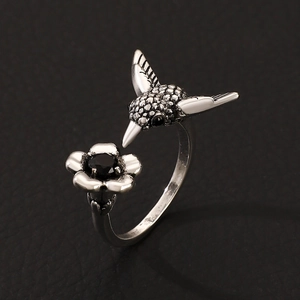 Elegant hummingbird and flower ring in antique silver finish with a black gemstone