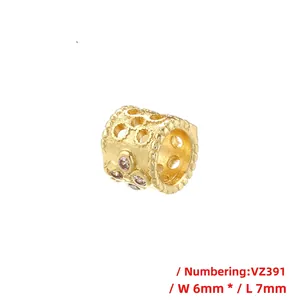 Close-up of golden hollow cylinder bead with white round zircon stones, 6mm by 7mm