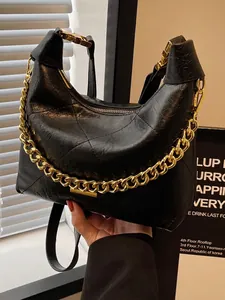 Quilted black hobo bag with thick gold chain handle and classic diamond pattern