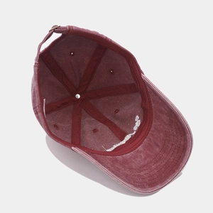 Detail of adjustable metal buckle and inner structure of washed red cotton baseball cap