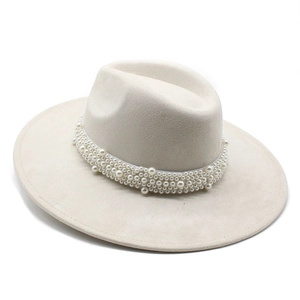 Close-up of cream wide brim fedora hat featuring elegant faux pearl beaded band detail