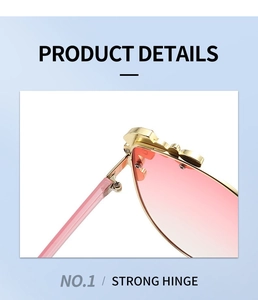 Detail view of reinforced metal hinge and pink gradient lens on cat-eye sunglasses