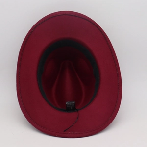Detail view of burgundy felt fedora inner lining with size 57 label and 100% polyester tag
