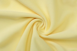 Primer plano de la textura de tela plisada amarillo pálido y detalles del tejido fino