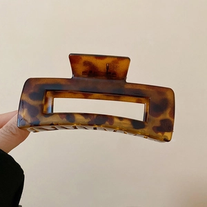 Macro view of tortoise shell acetate square hair claw clip with leopard pattern