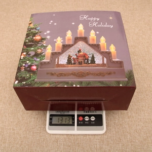 Detailed packaging of a Christmas candle lantern music box showing a 1313g product weight