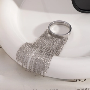 Modern silver chain tassel ring with minimalist multi-strand dangling design on white ceramic