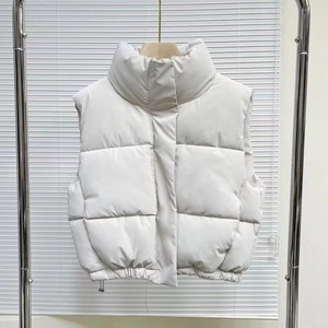 Short white puffer vest for women featuring a stand collar and adjustable drawstring hem
