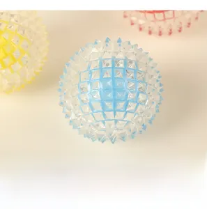 Detail of spiked textured dog massage ball made of blue translucent silicone material