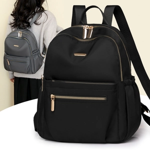 Detail view of water-resistant nylon backpack with smooth metal zippers and side pockets