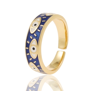 Detail of gold evil eye open ring featuring blue enamel inlay and adjustable band