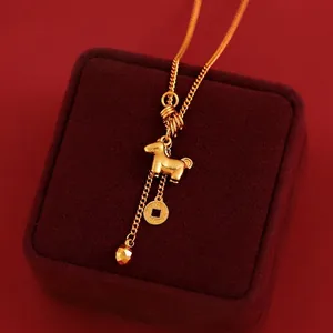 Gold zodiac horse pendant necklace with lucky coin and faceted bead on red velvet