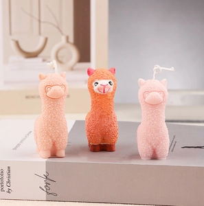 Detailed view of alpaca shaped candles with realistic fur textures and cotton wicks