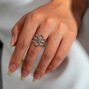 Close-up of silver horsebit stack ring on finger, punk style stainless steel jewelry