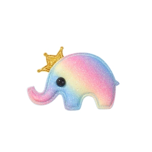 Detail of glitter elephant hair clip with gold crown and rainbow gradient finish
