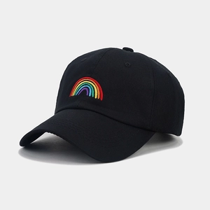 Close-up of rainbow embroidery on a black cotton baseball cap with detailed stitching