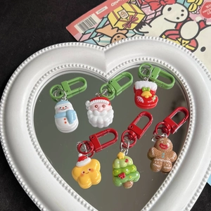 Set of six Christmas resin keychains with Santa and snowman on a heart mirror tray