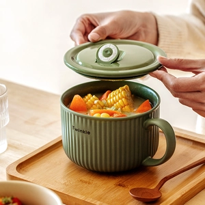 Green ceramic noodle bowl with lid, handle and date tracker shown in a lifestyle setting