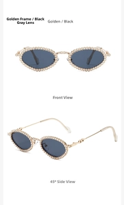 Close-up of golden oval sunglasses with sparkling rhinestones and black-gray lenses