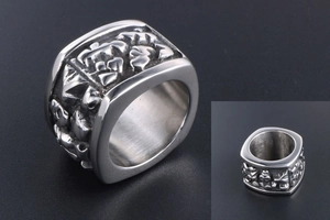 Macro detail of silver titanium steel signet ring with vintage embossed patterns