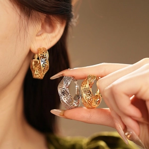Twisted hollow hoop earrings with classic Greek meander pattern in gold and silver