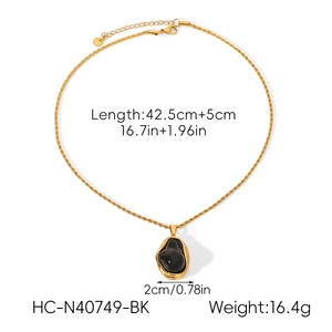 Detailed view of baroque pearl necklace with twisted rope chain and black onyx pendant