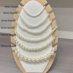 Detail view of white pearl beads in multiple sizes from 4mm to 14mm for DIY jewelry