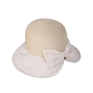 Summer straw bucket hat for women with large cream bow decoration and wide sun brim