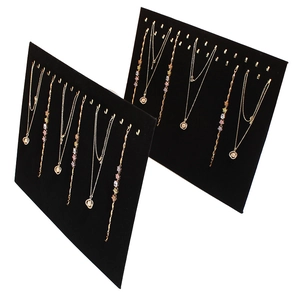 Black velvet jewelry display board with metal hooks for necklaces and bracelets