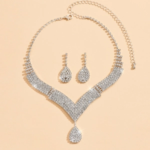 Elegant bridal jewelry set with V-shaped silver crystal necklace and teardrop earrings