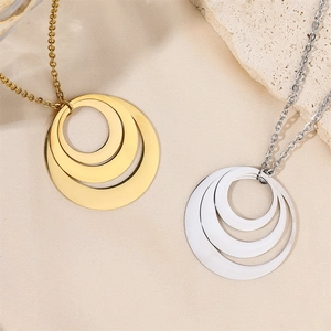 Detail of three-tier concentric circle pendants in 18k gold and silver stainless steel