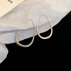 Minimalist silver teardrop earrings with a sleek polished finish and hook design