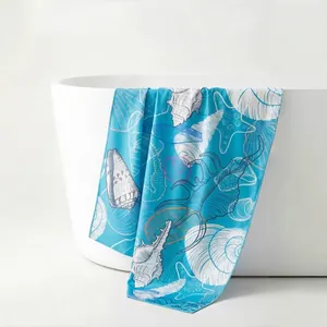 Microfiber beach towel with blue seashell prints draped on a bathtub, soft and safe