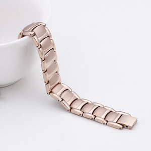 Detailed close-up of rose gold plated titanium magnetic bracelet with brushed metal finish