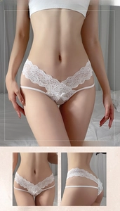 Detailed macro of white floral lace underwear with V-waist cross straps and hollow mesh