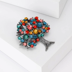 Detailed macro view of tree of life brooch with vibrant colorful rhinestones and dark metal