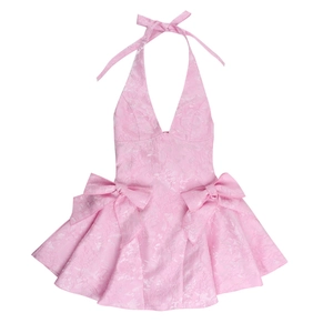 Detailed view of pink halter neck dress with jacquard fabric and double bow waist detail