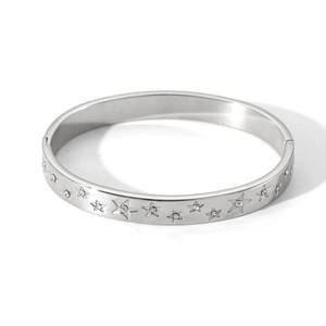 Detail shot of a silver star-patterned bangle with measurements 6cm diameter and 0.8cm width