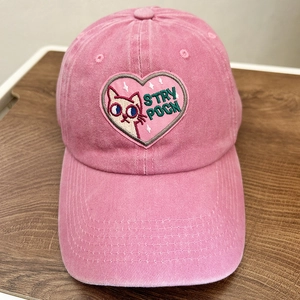 Pink washed canvas baseball cap with embroidered cartoon cat patch and heart design