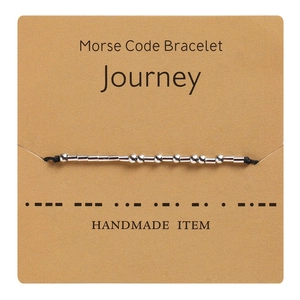 Detail showing Morse code silver beads on black wax rope bracelet for Journey theme