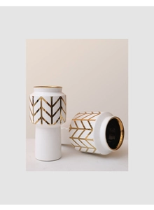 Close-up of modern ceramic vase with golden chevron pattern and polished gold glaze rim