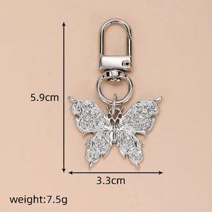 Detail showing 5.9cm silver butterfly keychain with intricate embossed wing textures