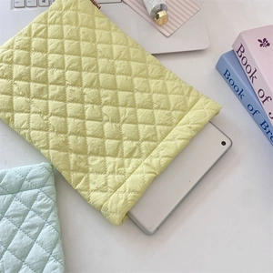 Detailed view of soft quilted diamond pattern on colorful laptop sleeve with padding