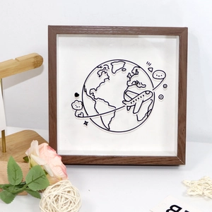 Macro view of square wooden ticket box with iron wire globe art and 3D airplane design