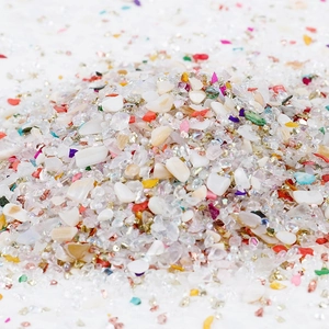 Close-up of irregular multi-color glass gravel and shell fragments for DIY crafts decoration