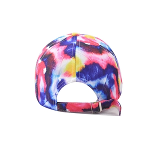 Detail view of cotton baseball cap back with colorful tie-dye and adjustable metal buckle