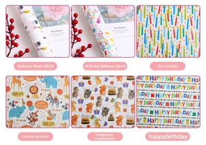 Detailed view of assorted cartoon birthday wrapping papers featuring moon and balloon patterns