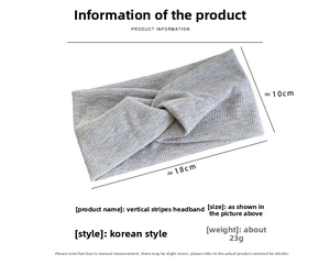 Detailed view of grey ribbed knitted headband with cross twist design and size dimensions
